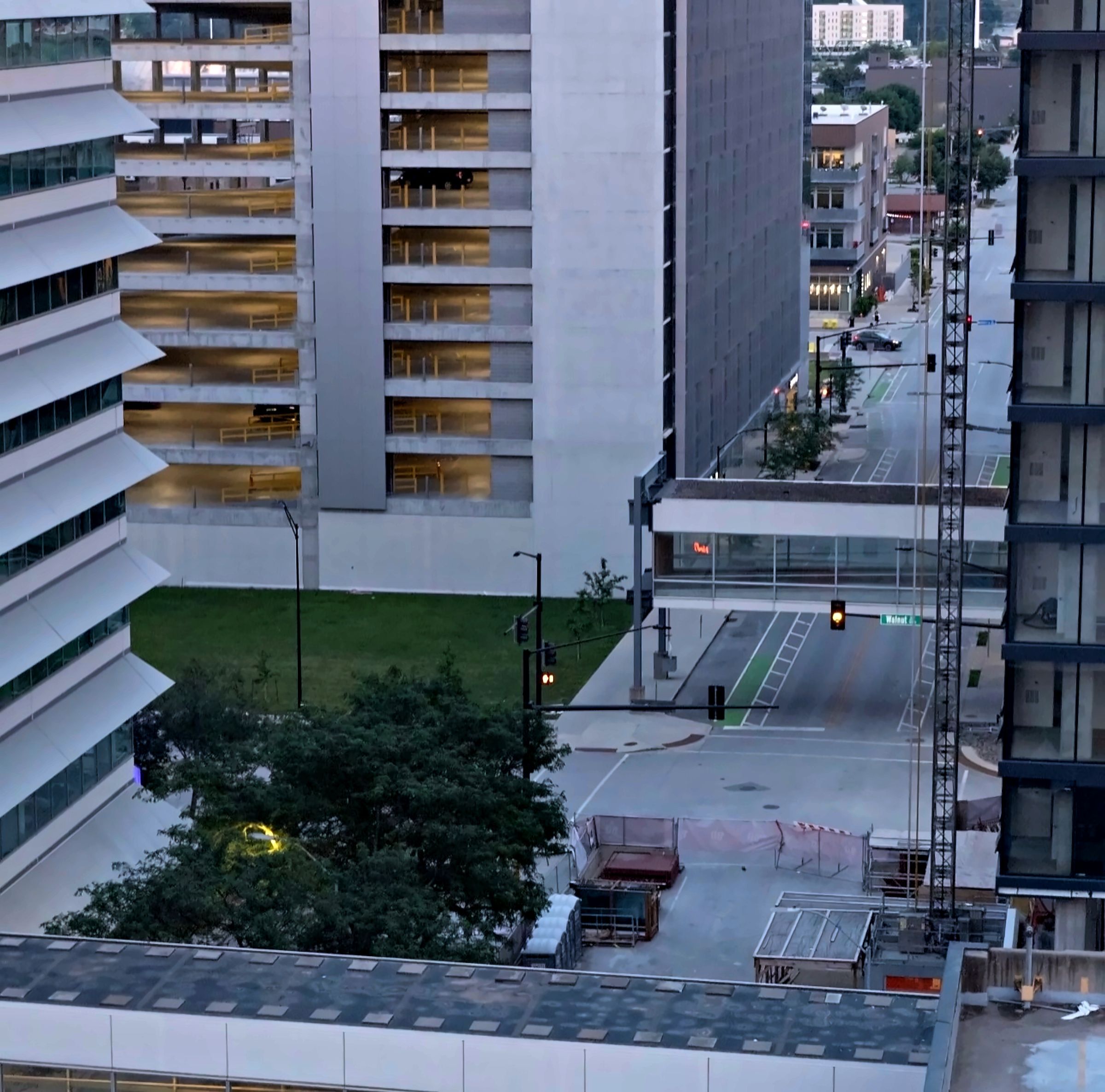 Downtown Des Moines at dusk with a skywalk crossing Walnut Street